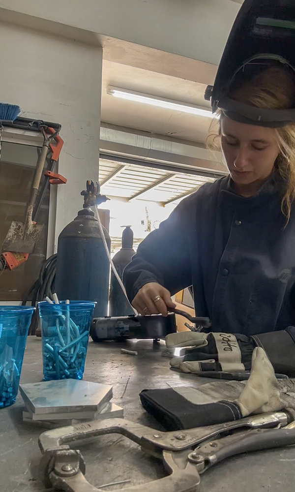 Kelly preparing to solder small pieces of the sculpture. 