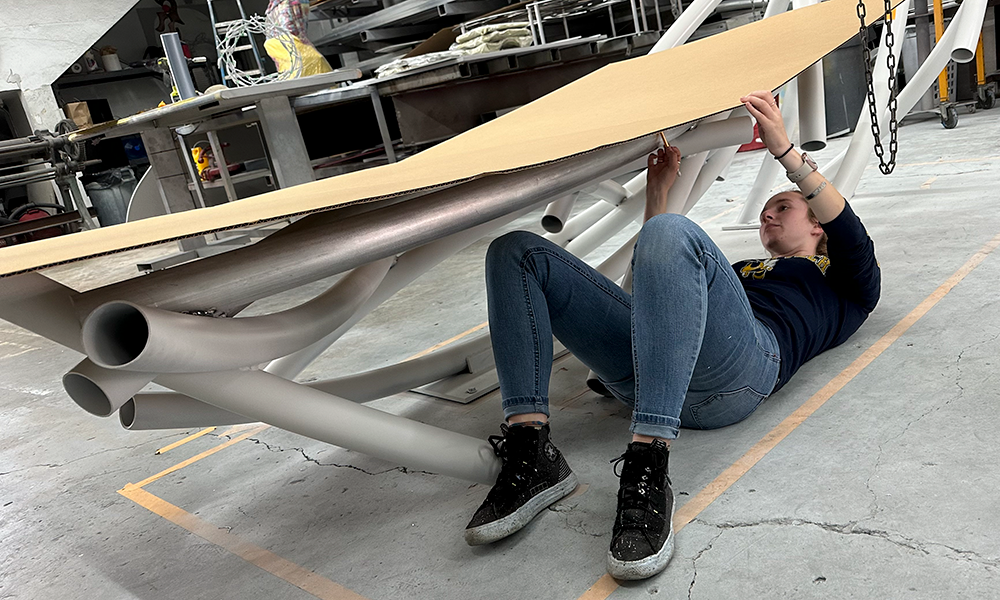 Kelly under the future sculpture's bench.