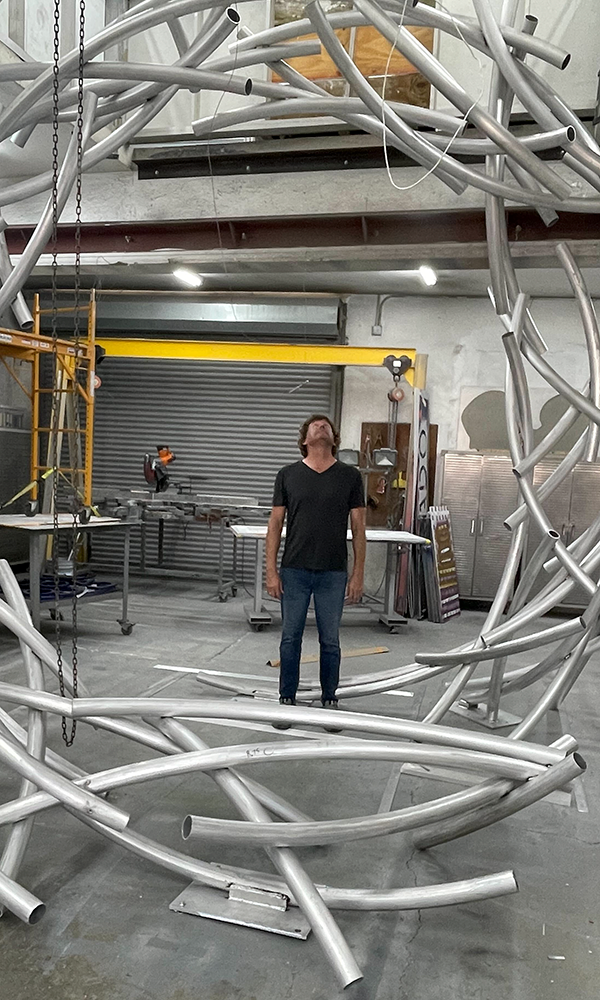 Luis Torruella standing inside the sculpture.