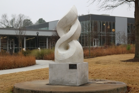 Smooth white marble, only lightly veined, sculpted as an abstract rendering of the olympic flame.