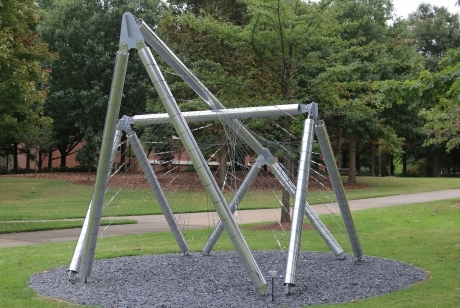 Shiny metal tubing in overlapping shapes with webs of metal stretched from pole to pole