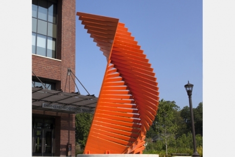 bright orange steel boards stacked in a twisted tower