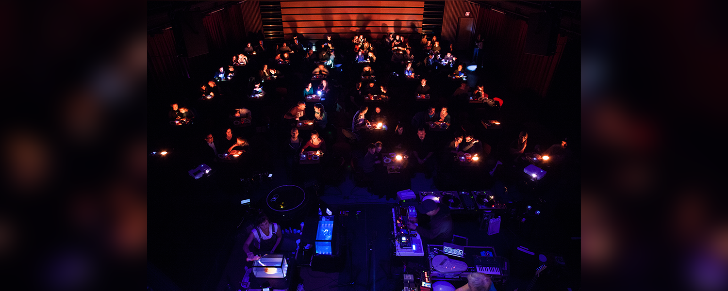 In a darkened theater there are 50 illuminated seating areas each with their own turntable.