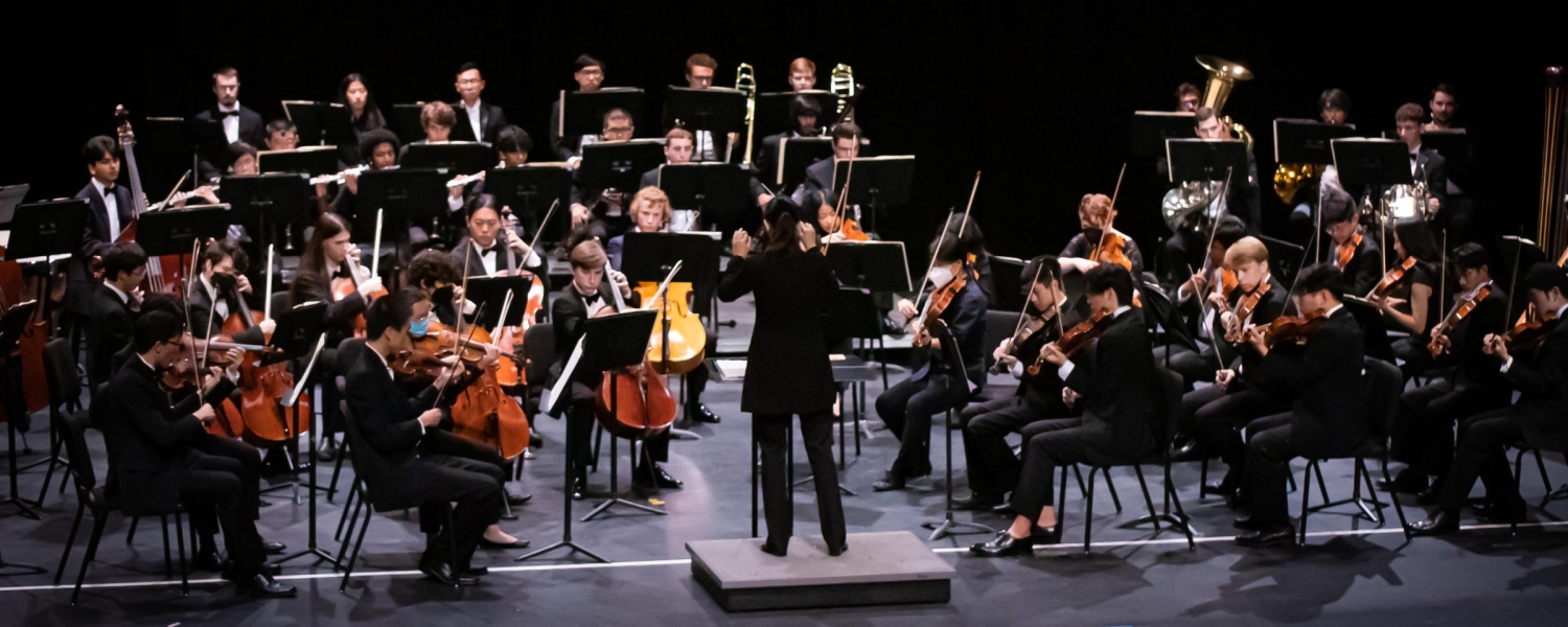 Group of musicians gathered on stage playing various instruments