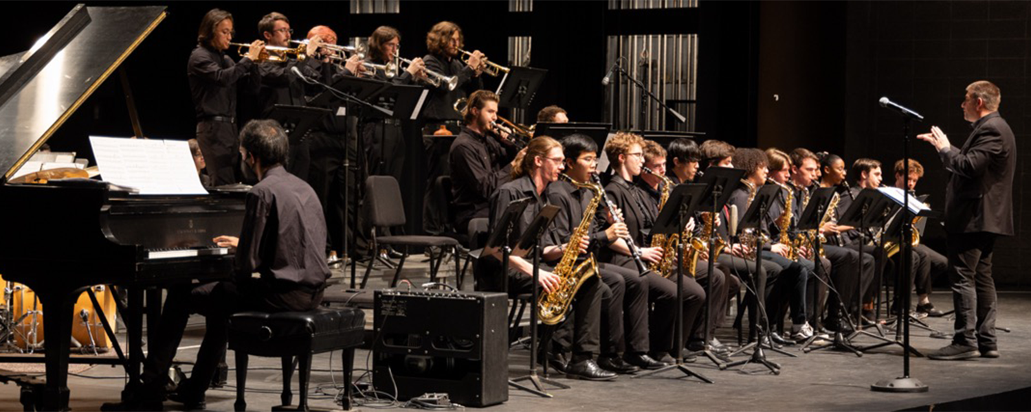 Group of musicians playing various instruments on stage