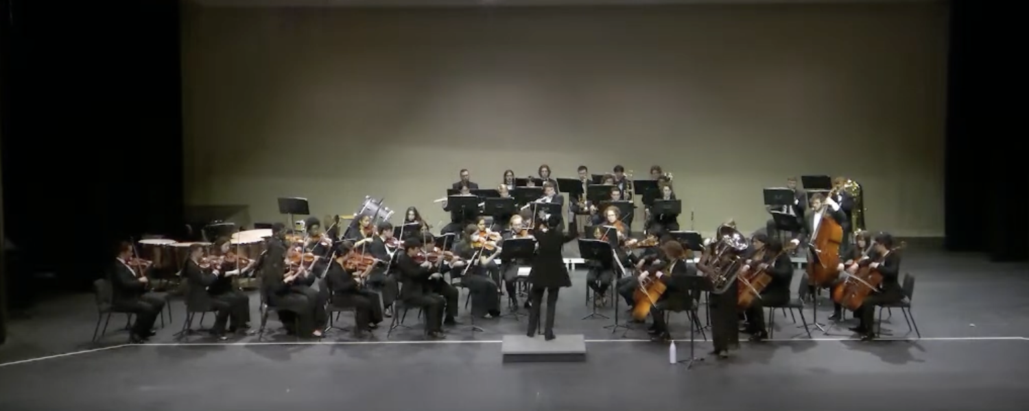 Group of musicians gathered on stage playing various instruments