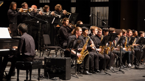 Group of musicians playing various instruments on stage