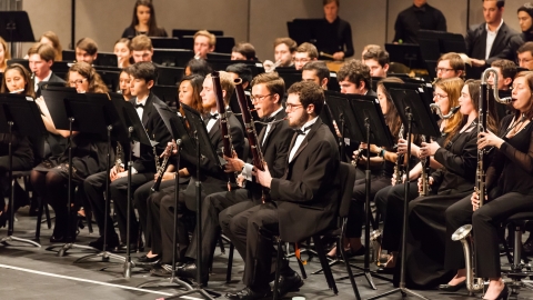 Group of musicians gathered on stage playing various instruments