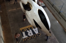 White aluminum amorphous shape with openings, suspended in the atrium of the Clough Undergraduate Learning Commons