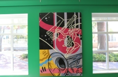 A painted panel each with images of dance, music, and art, the figures outlined in black and filled in with vibrant abstract colors and shapes