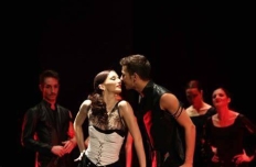 a ballet duet. The man and woman are close, face to face